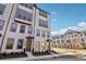 Three-story townhome with light brick exterior and modern design at 3891 Allegretto Cir, Atlanta, GA 30339