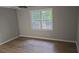 Spacious bedroom with large window and wood-look flooring at 1947 Kensington High Sw St, Lilburn, GA 30047