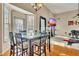 Sunlit dining area features a glass-top table, perfect for Gathering meals at 3125 Esplanade Sw Cir, Atlanta, GA 30311