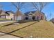 Landscaped yard with a brick house and a driveway at 3125 Esplanade Sw Cir, Atlanta, GA 30311