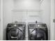 Bright laundry room, complete with shelving and Samsung washer and dryer at 277 Edison Dr, Stockbridge, GA 30281