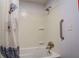 Bathroom with tub, shower, grab bar, and floral shower curtain at 138 Mcdonald Rd, Covington, GA 30014