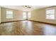 Large living room featuring hardwood-style tile flooring and multiple windows at 138 Mcdonald Rd, Covington, GA 30014