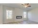 Living room with fireplace, ceiling fan, and lots of natural light at 2296 Cadenza Cir, Dacula, GA 30019