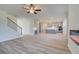 Open living room with hardwood floors, fireplace, and view of staircase at 2296 Cadenza Cir, Dacula, GA 30019