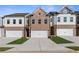 Townhouse with a brick and white siding exterior and an attached two-car garage at 867 Eagle Avenue, Riverdale, GA 30247