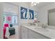 Double vanity bathroom with modern fixtures and a view into a bedroom at 2750 Dolce Rd, Dacula, GA 30019