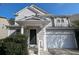 Two story home with gray siding, dark door, and white garage door at 2786 Alix Way, Lithia Springs, GA 30122