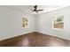 Spacious bedroom with hardwood floors and two large windows at 2133 Trailwood Rd, Decatur, GA 30032