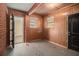 Unfinished basement area with wood paneling and exterior access at 2757 Arrowood Dr, East Point, GA 30344