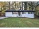 Charming ranch home with white brick exterior, dark shutters, and a well-manicured lawn at 4010 Princeton Sw Pl, Atlanta, GA 30331