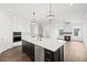 Open kitchen with island, gas range, and a view into the living area at 4002 Moody Ln, Woodstock, GA 30188