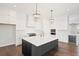Gourmet kitchen with white cabinets, quartz countertops, and a large island at 4002 Moody Ln, Woodstock, GA 30188
