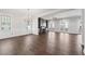 Open living room with hardwood floors, fireplace, and built-in shelves at 4002 Moody Ln, Woodstock, GA 30188