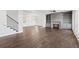 Living room with hardwood floors, fireplace, built-in shelving, and open floor plan at 4002 Moody Ln, Woodstock, GA 30188