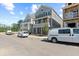 New homes on a tree-lined street with white vans at 4002 Moody Ln, Woodstock, GA 30188