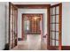 Hallway with hardwood floors and wooden doors leading to other rooms at 1225 Clifton Rd, Atlanta, GA 30307