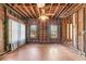 Living room with hardwood floors, exposed beams, and windows; needs renovation at 1225 Clifton Rd, Atlanta, GA 30307