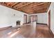 Spacious living room featuring hardwood floors, exposed beams, and a fireplace at 1225 Clifton Rd, Atlanta, GA 30307