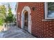 Side porch with arched doorway and wrought iron railings at 1225 Clifton Rd, Atlanta, GA 30307