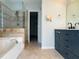 Large bathroom boasts a soaking tub, walk-in shower, and double vanity at 2936 Winter Rose Ct, Atlanta, GA 30360