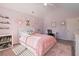 Light and airy bedroom with a pink theme, featuring a comfy bed and a desk at 4105 Woodwind Dr, Cumming, GA 30028