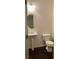 Simple bathroom with pedestal sink and dark hardwood floor at 5671 Radford Loop, Fairburn, GA 30213