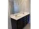 Double vanity bathroom with dark brown cabinets and a large mirror at 5671 Radford Loop, Fairburn, GA 30213