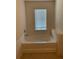 Bathroom with an oval garden tub and a window with blinds at 5671 Radford Loop, Fairburn, GA 30213