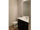 Clean bathroom with dark vanity and a mirror at 5671 Radford Loop, Fairburn, GA 30213