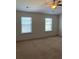 Spacious bedroom with neutral carpeting and two large windows at 5671 Radford Loop, Fairburn, GA 30213