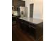 Kitchen island with granite countertop and dark wood cabinets at 5671 Radford Loop, Fairburn, GA 30213