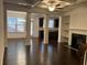 Open concept living room with dark hardwood floors at 5671 Radford Loop, Fairburn, GA 30213