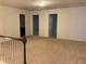 Open loft area with carpet and access to bedrooms and bathroom at 5671 Radford Loop, Fairburn, GA 30213