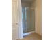 Clean shower with glass enclosure and neutral tile flooring at 5671 Radford Loop, Fairburn, GA 30213