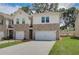 Two-story brick townhome with a two-car garage and landscaped front yard at 455 Payne Dr, Mcdonough, GA 30253