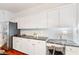 White kitchen cabinets with granite countertops and built-in desk at 3175 Blairhill Ct, Atlanta, GA 30340