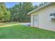 Side view of a house with a deck and a grassy yard at 1565 Dr Bramblett Rd, Cumming, GA 30028