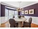 Round dining table with four chairs in a room with purple walls at 1415 Chadwick Ridge Ct, Lawrenceville, GA 30043