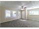 Bright living room with neutral carpeting and ceiling fan at 1777 W Austin Rd, Decatur, GA 30032