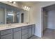 Double vanity bathroom with a large mirror and walk-in closet at 209 Chiswick Loop, Stockbridge, GA 30281