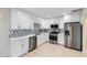 Modern kitchen with white cabinets, stainless steel appliances, and quartz countertops at 1676 Sylvan Sw Rd, Atlanta, GA 30316