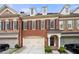 Brick townhouse with 2-car garage, inviting front entrance, and well-manicured landscaping at 2252 Edgartown Se Ln # 2, Smyrna, GA 30080