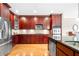 Modern kitchen with cherry wood cabinets, granite countertops, and stainless steel appliances at 2252 Edgartown Se Ln # 2, Smyrna, GA 30080