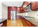 Modern kitchen with cherry wood cabinets, granite countertops, and stainless steel appliances at 2252 Edgartown Se Ln # 2, Smyrna, GA 30080