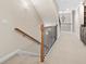 Elegant staircase with wood railing and neutral carpeting at 2252 Edgartown Se Ln # 2, Smyrna, GA 30080