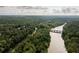 Aerial view of a river winding through a wooded area with a bridge at 314 River Glen Dr, Roswell, GA 30075