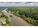 Aerial view highlighting a home nestled within a lush, riverside forest at 314 River Glen Dr, Roswell, GA 30075