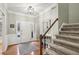 Welcoming foyer with hardwood floors, staircase, and front door at 314 River Glen Dr, Roswell, GA 30075