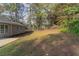 Large backyard with grassy area and trees at 7133 Pineview Sw Dr, Covington, GA 30014